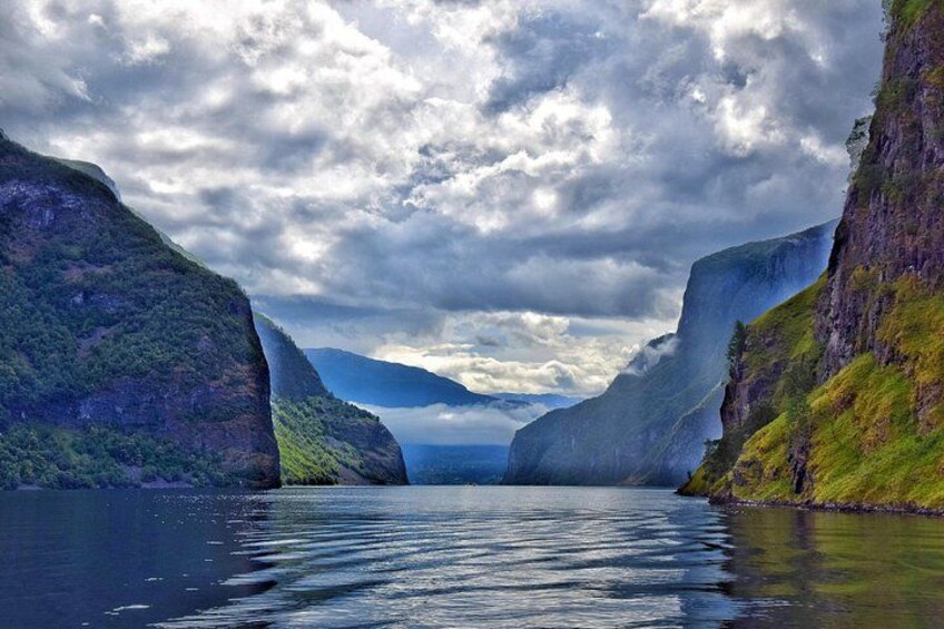 A fjord with steep cliffs and calm water. 3