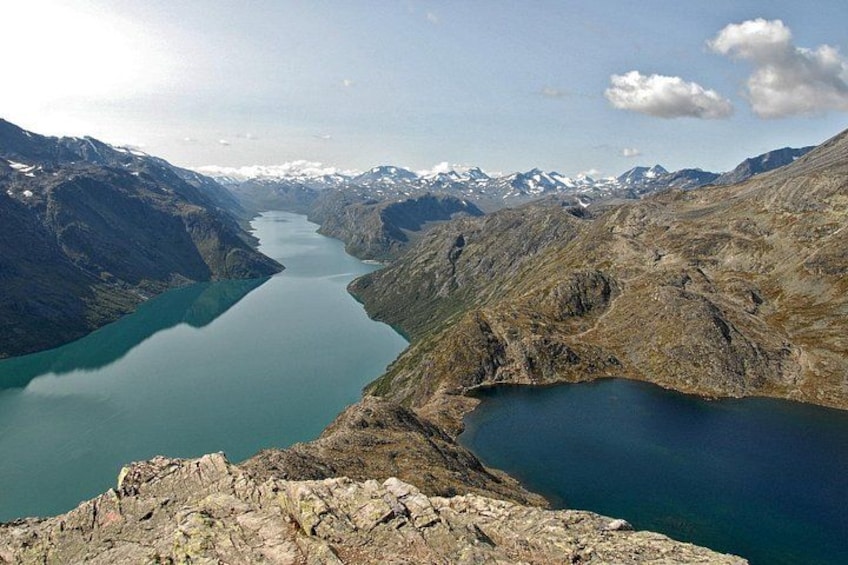 A mountainous landscape with a lake and snow-capped peaks. 2