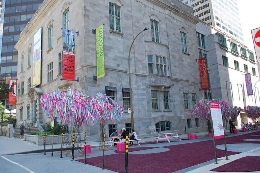 A historic building with banners and a red carpeted area. 3