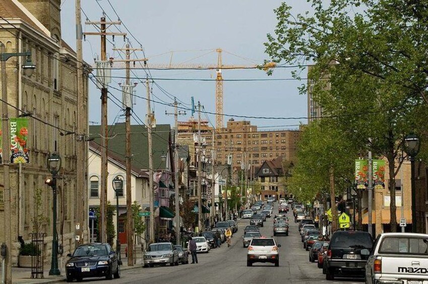 A busy urban street with cars, buildings, and construction cranes. 2