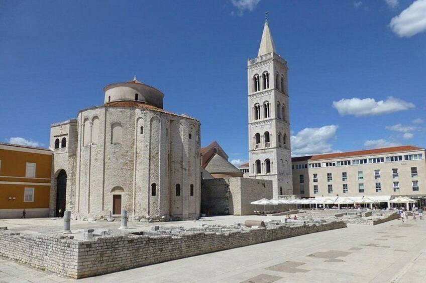 A historic building with a round dome and a tall bell tower. 1