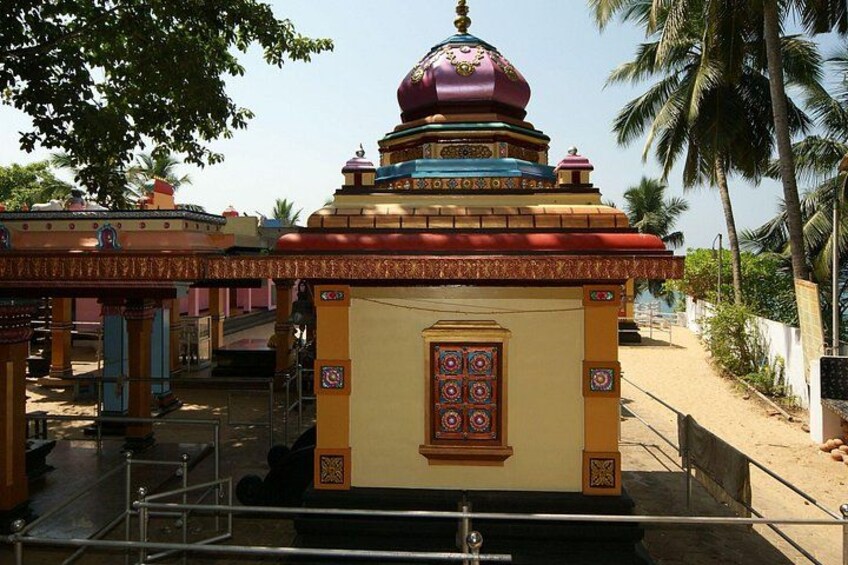 A temple with a multi-tiered roof, a central shrine, and a surrounding walkway. 4