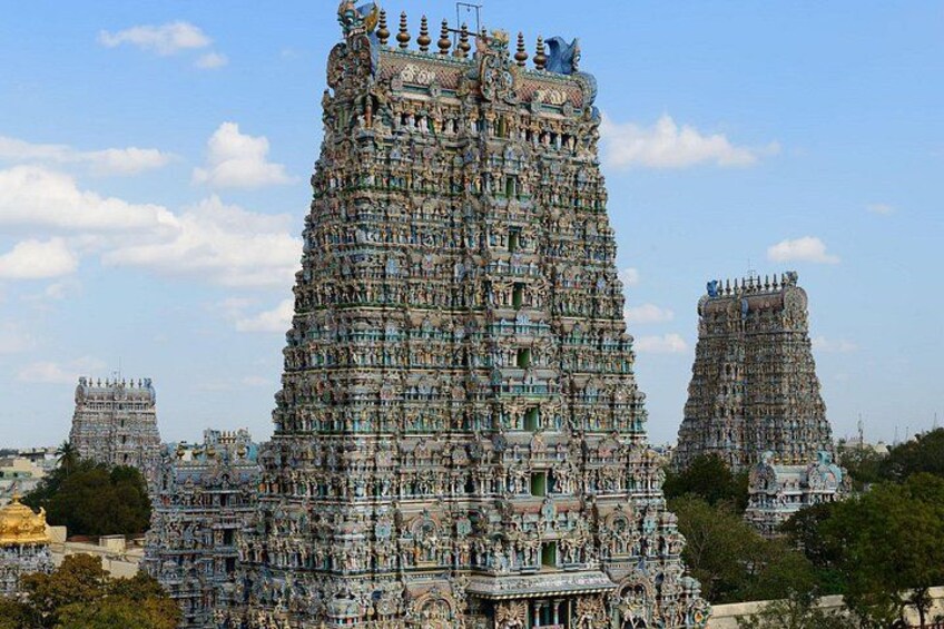 A large, intricately decorated temple tower with multiple tiers and detailed carvings. 3
