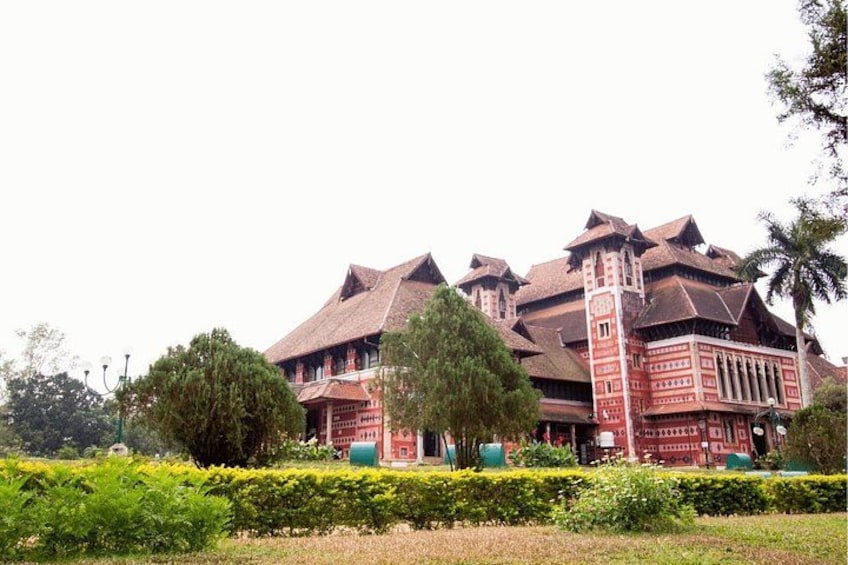 A large, red building with multiple roofs and a central tower. 2