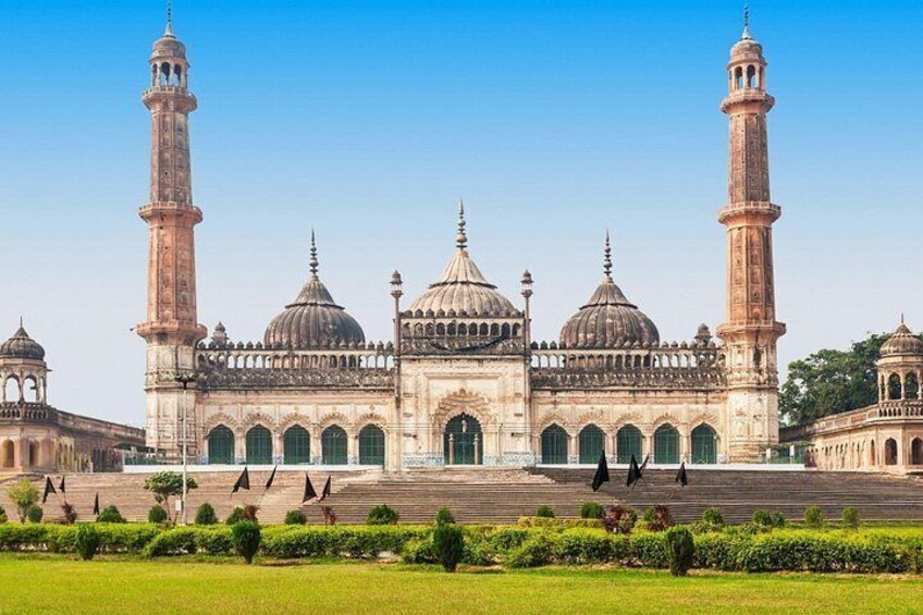 A large mosque with multiple domes and minarets, surrounded by a well-maintained garden. 5