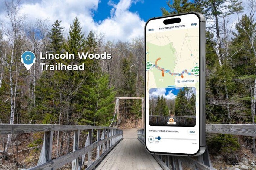 A smartphone displaying a map of the Lincoln Woods Trailhead with a wooden bridge and forested area in the background. 3