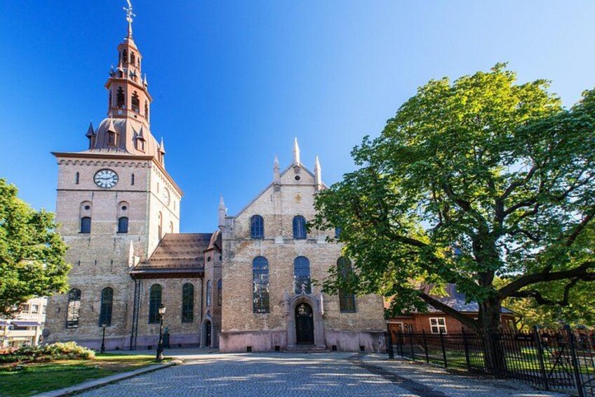 A historic church with a prominent tower and clock. 2