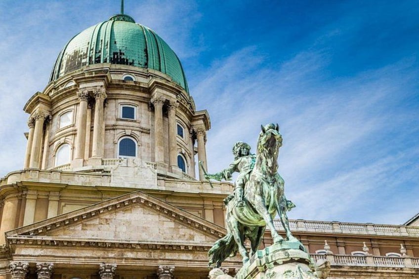 A historic building with a dome and a statue of a horse and rider. 4