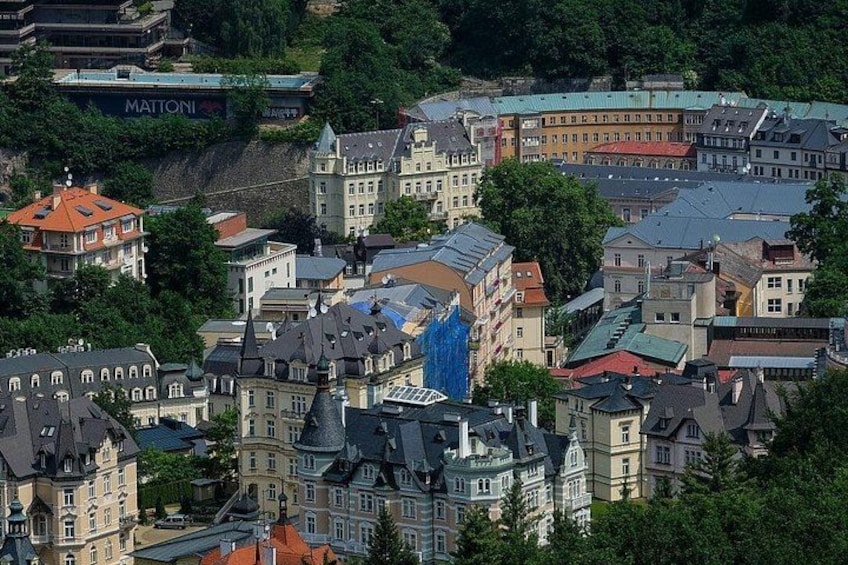 A densely built urban area with historic architecture, including a prominent building with a blue roof and a large blue structure in the center. 3