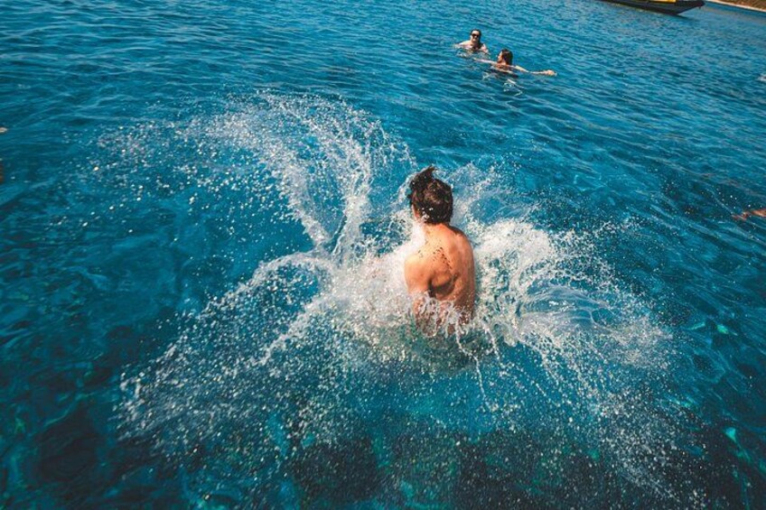 A person swimming in a pool with splashes of water around them. 3