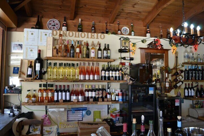 A bar with shelves of various bottles and a sign with Cyrillic text. 3