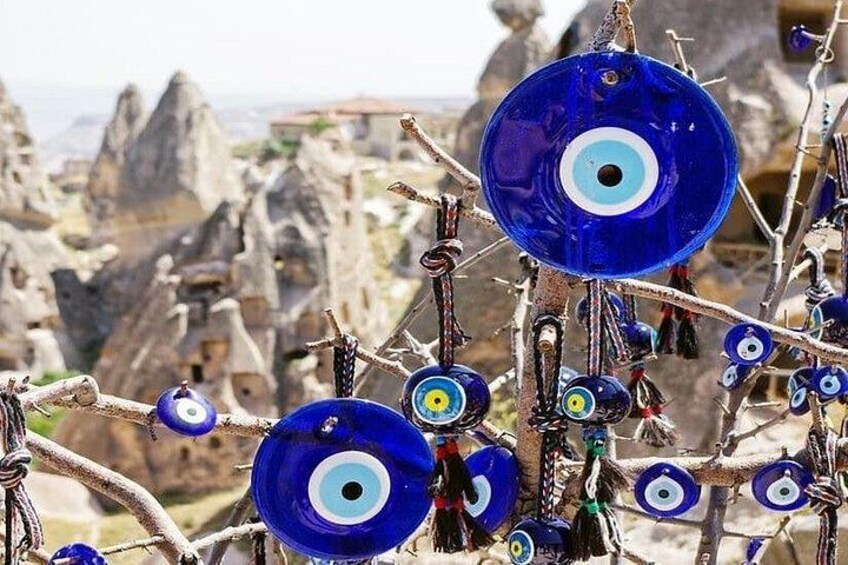 A collection of blue and white decorative items, possibly wind chimes, against a backdrop of rocky, mountainous terrain. 2