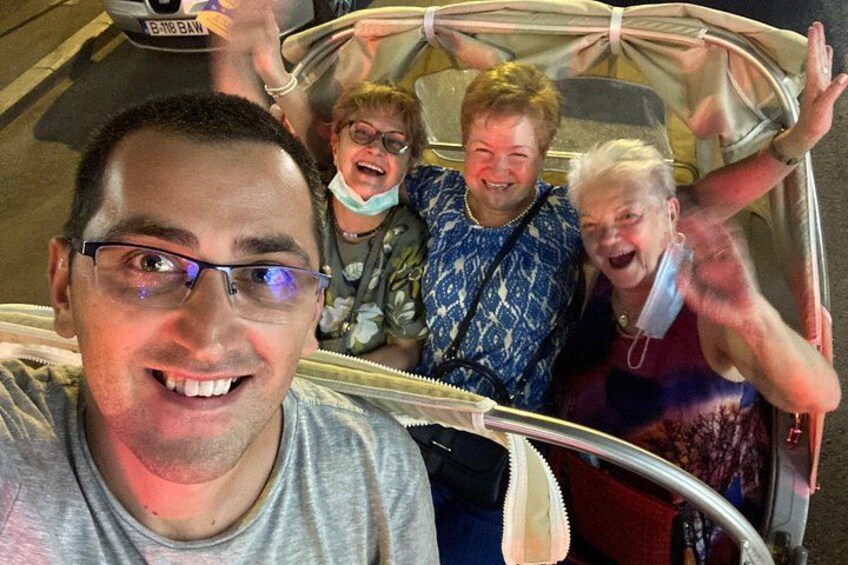 A group of people in a vehicle with a large open back. 5