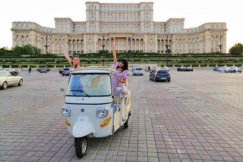 Happy girls in tuk tuk in front of Palace of Parliament 2