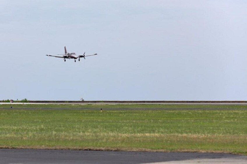 An airplane landing on a runway. 4