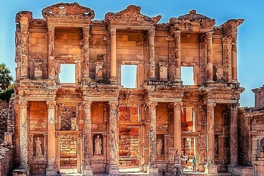 An ancient stone structure with columns and intricate carvings. 2