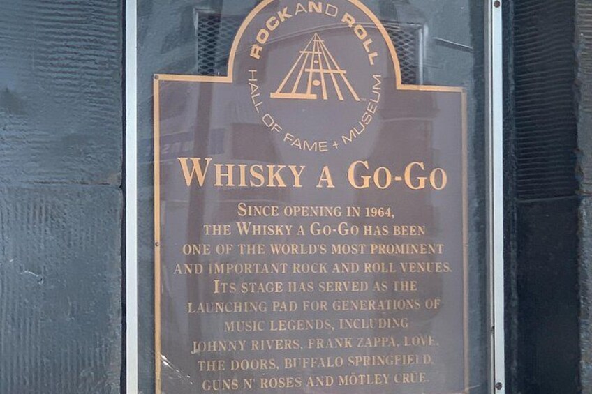 A plaque on a glass window with text about the Whisky A Go-Go. 5