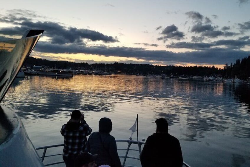 Three people on a boat, a calm lake, and a sunset. 2