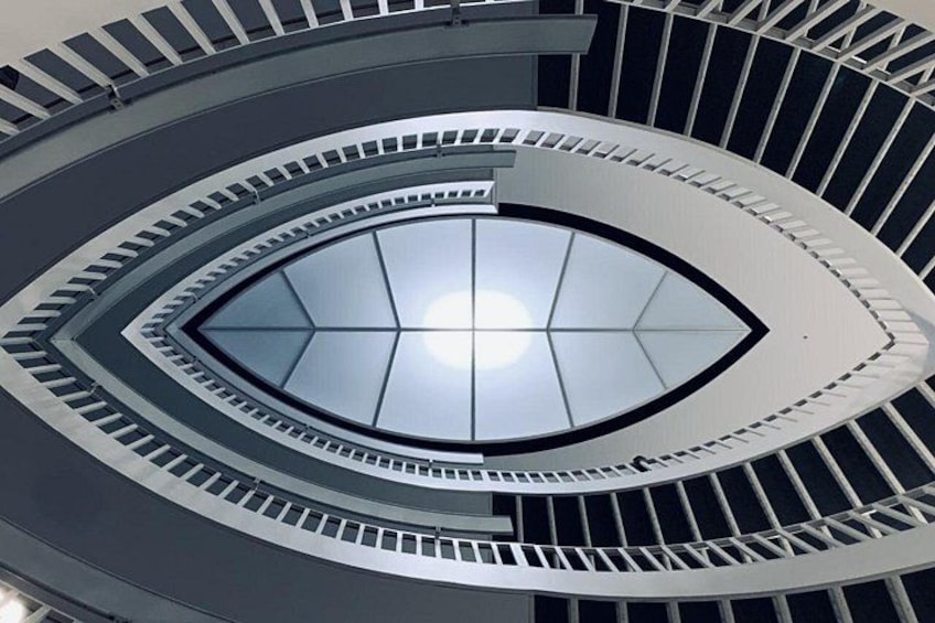 A spiral staircase with a glass dome at the top. 1