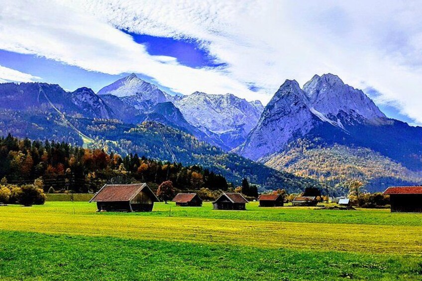 A mountainous landscape with houses in a valley. 2