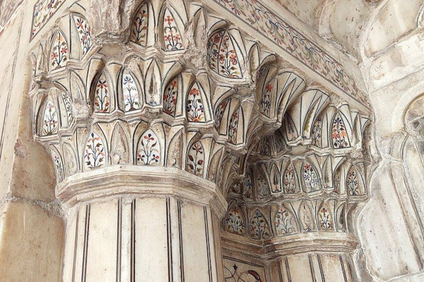 A stone architectural detail with intricate tracery and floral patterns. 2