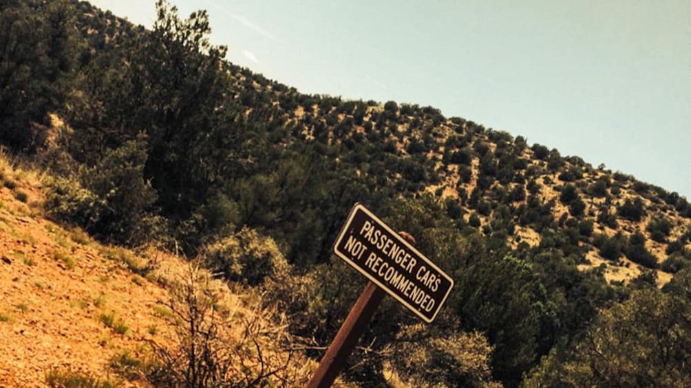 Warning sign along hike path to passenger cars.