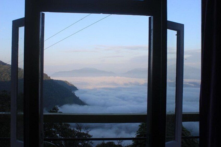 A mountain landscape with clouds below the peak. 4