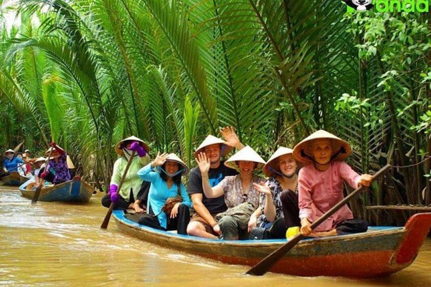 People in a boat on a river surrounded by dense palm trees. 1