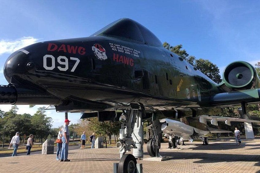 A military aircraft with the markings 'DAWG 097' and 'HAWG' on its nose. 1