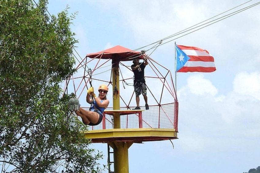 A zip-lining activity with a flag and a netted platform. 4
