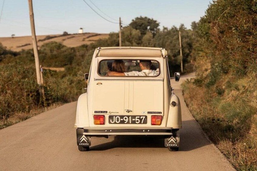 A beige off-road vehicle on a rural road with a license plate JO-91-57. 2