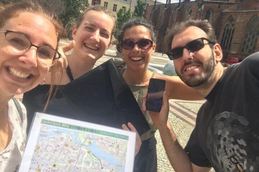 A group of people holding a map. 5