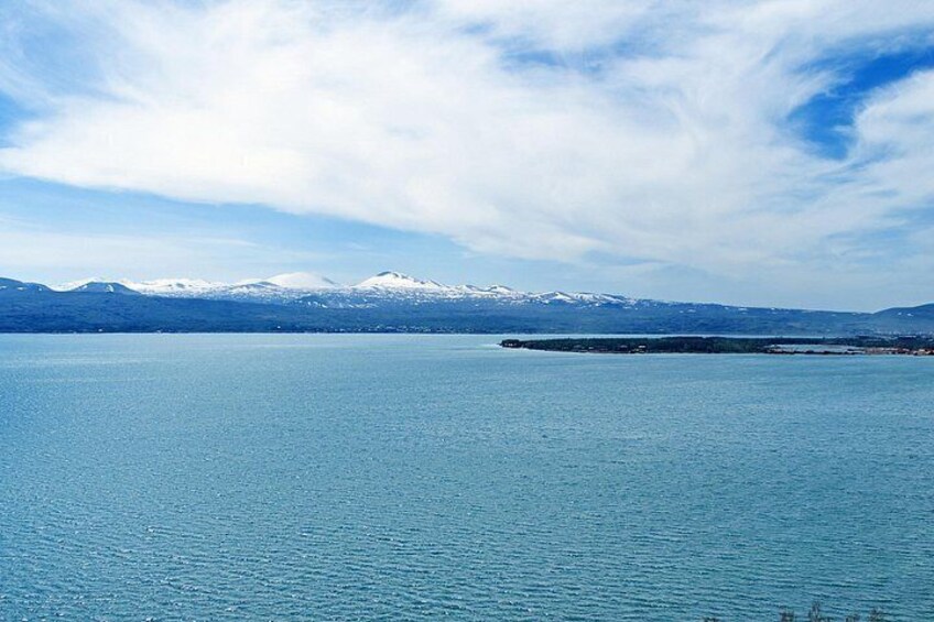 A calm lake with snow-capped mountains in the background. 2