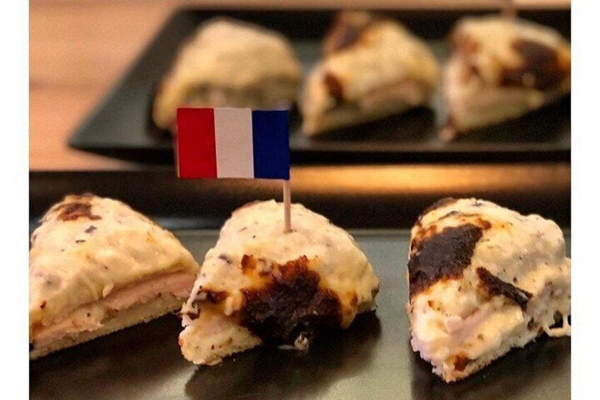 A food item with a small flag, possibly a pastry or sandwich, on a plate. 3