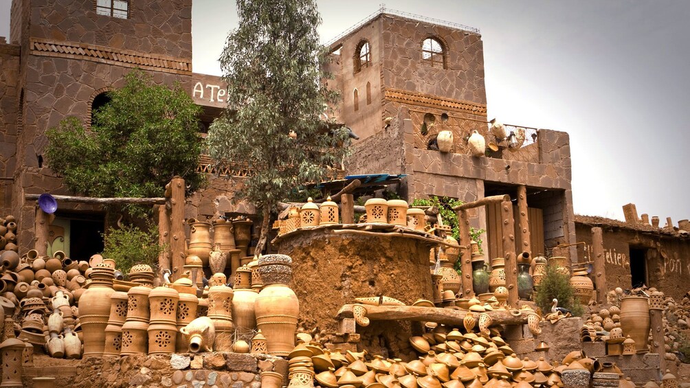 piles of clay pottery outside of stone buildings in Morocco