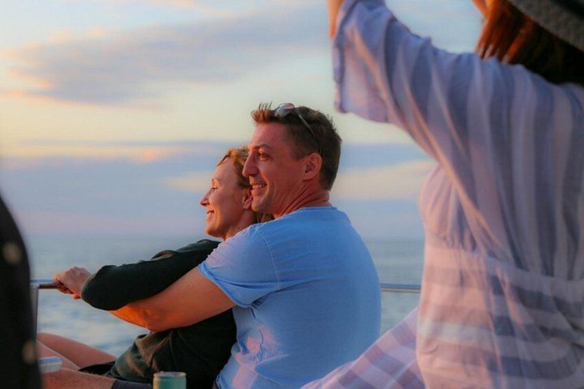 A couple enjoying a romantic moment on a sunset cruise 1