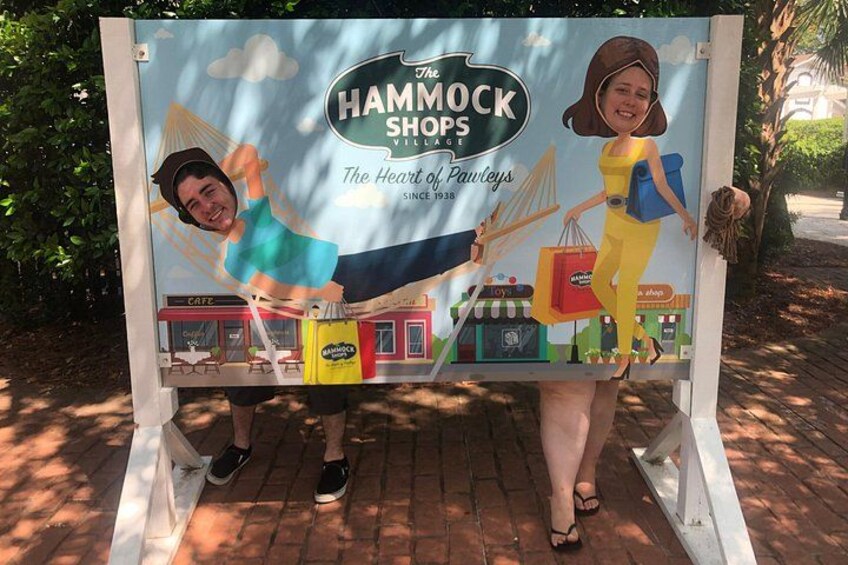 A sign with a cartoon character and the text 'The Hammock Shops Village.' 4
