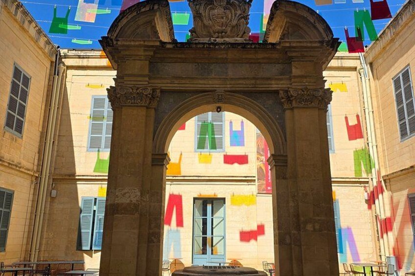 A historic archway with colorful flags. 2