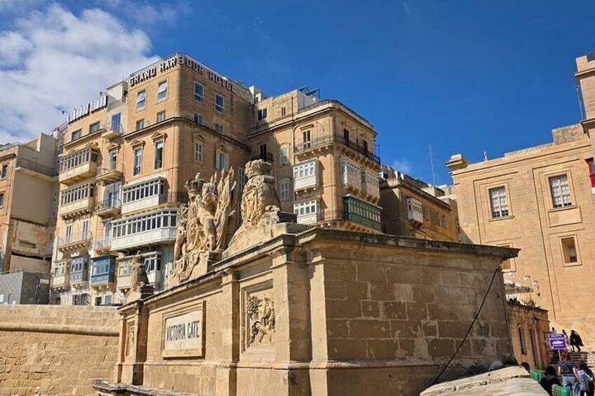 A historic building with ornate sculptures and a sign reading 'Grand Hotel.' 4