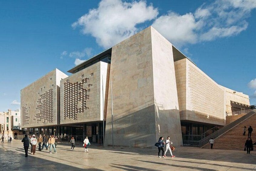 A modern building with a unique facade and a staircase leading to the entrance. 5