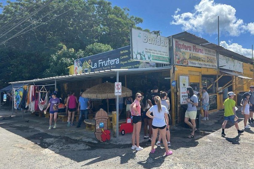 A street market with stalls, including one named 'La Frutera.' 5