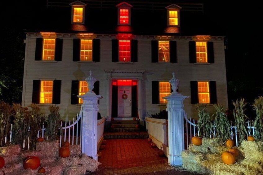 A large, illuminated building with a red-lit entrance and a central statue. 4