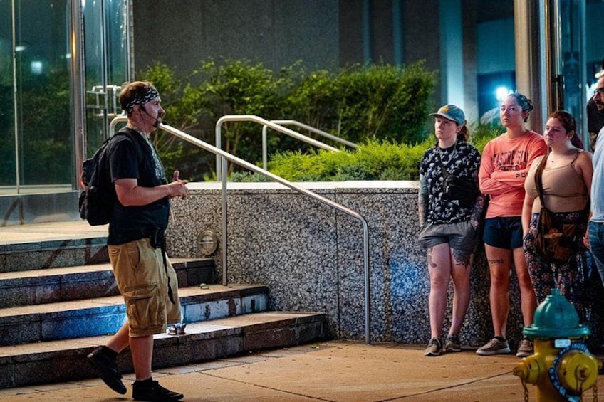 A person walking up stairs, a fire hydrant, and a group of people standing on the sidewalk. 2
