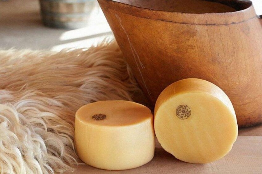 Two wooden bowls and a large pot on a textured surface. 3