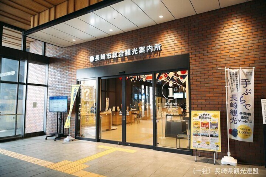 A building entrance with a brick facade, glass doors, and signage in Japanese. 5