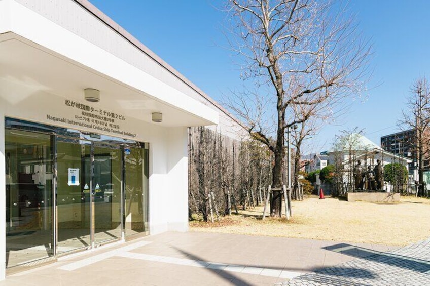 A building with a sign reading 'Nagasaki International Cruise Ship Terminal 2'. 4