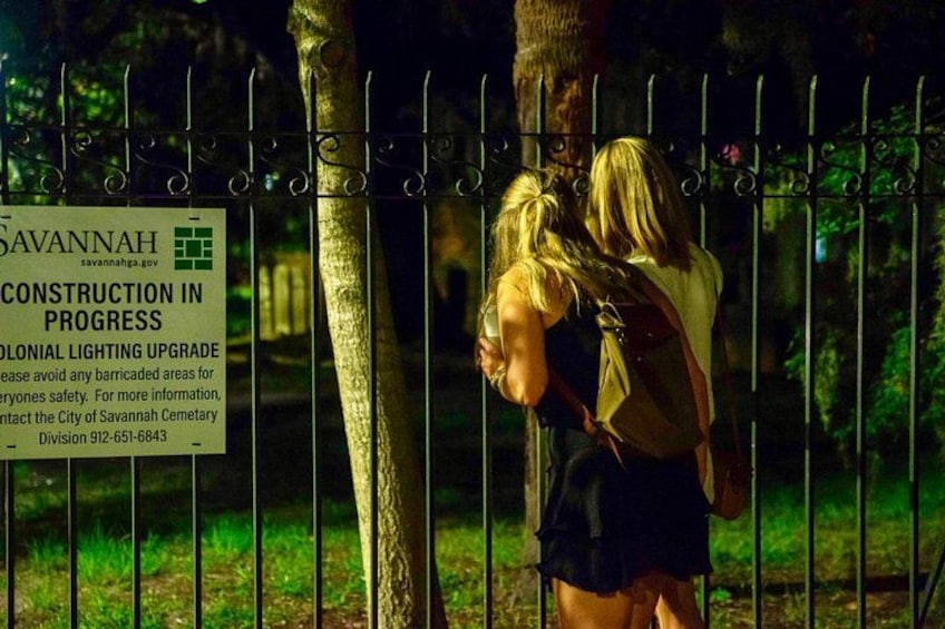 Two people walking past a sign about construction in progress. 5