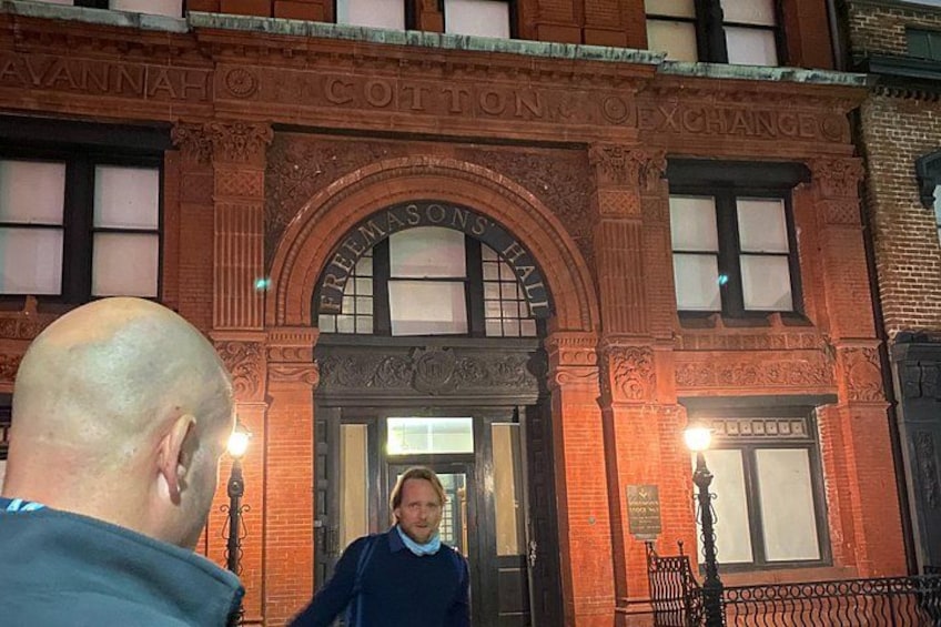 A historic building with ornate brickwork and a sign reading 'Freemason Hall.' 3