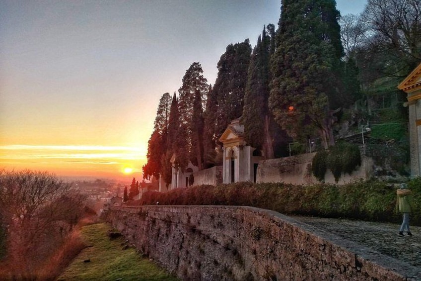 A sunset, a stone wall, and a building with columns. 5