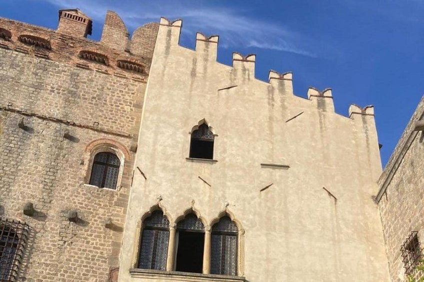 A castle with a large central tower, arched windows, and battlements. 2